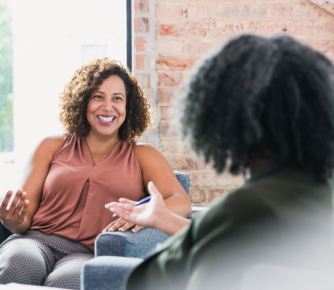 Two women engaging in a friendly conversation.