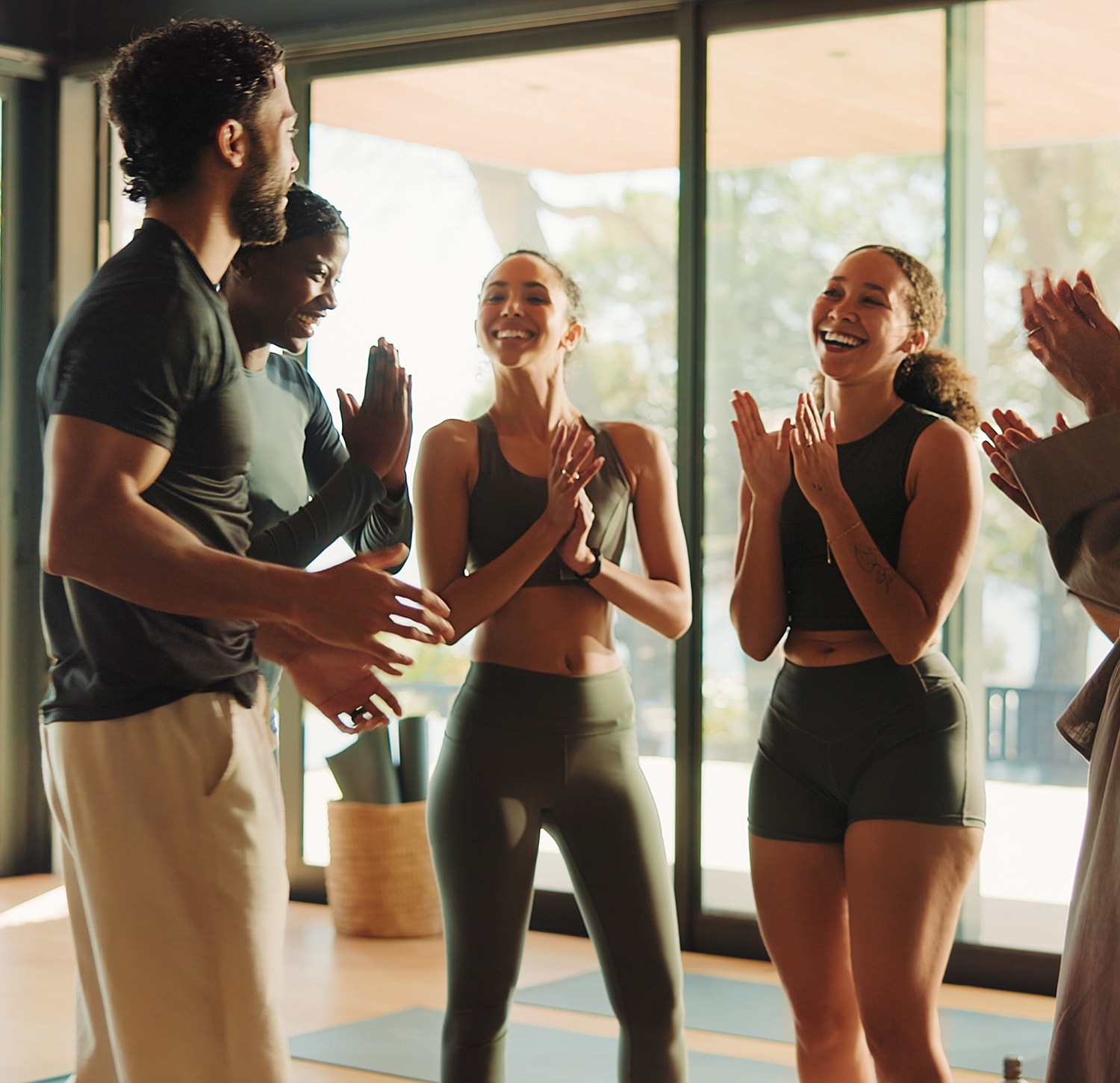 Group of friends celebrating fitness success indoors.