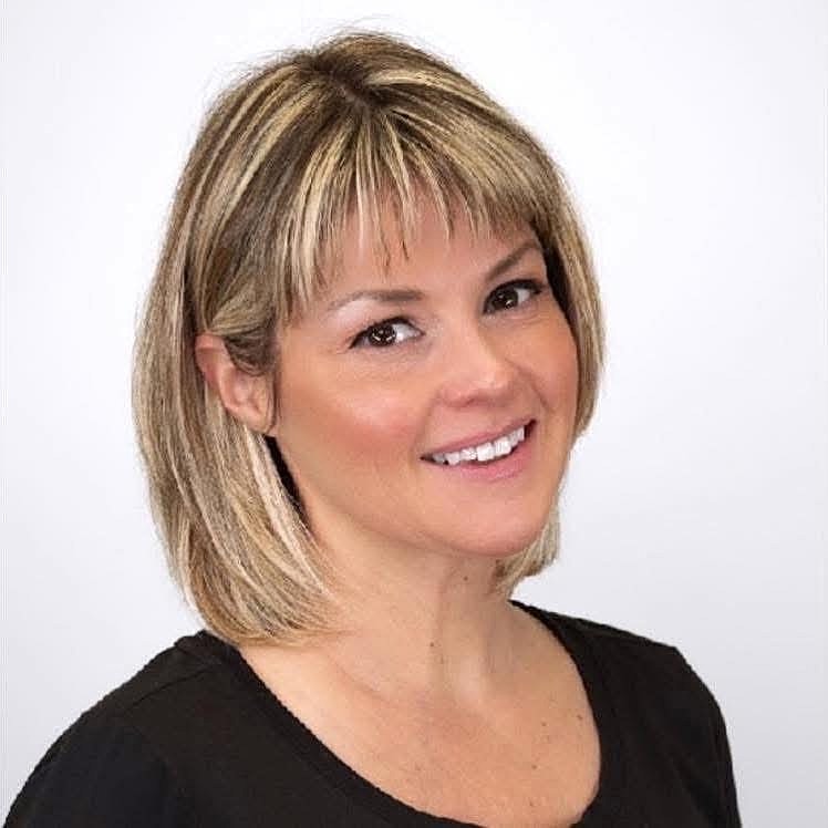 Smiling woman with shoulder-length blonde hair.