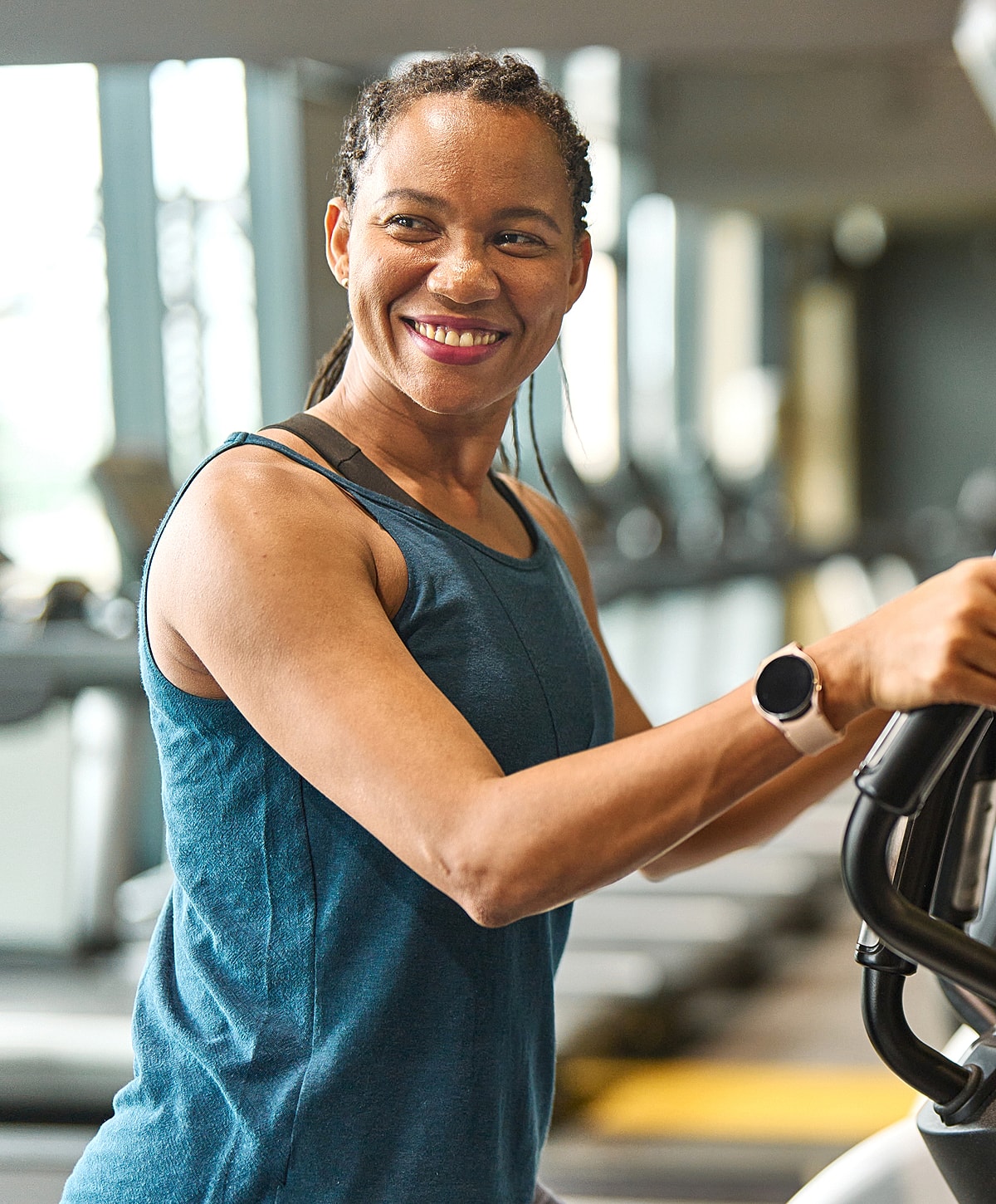 Smiling woman exercising in a gym.