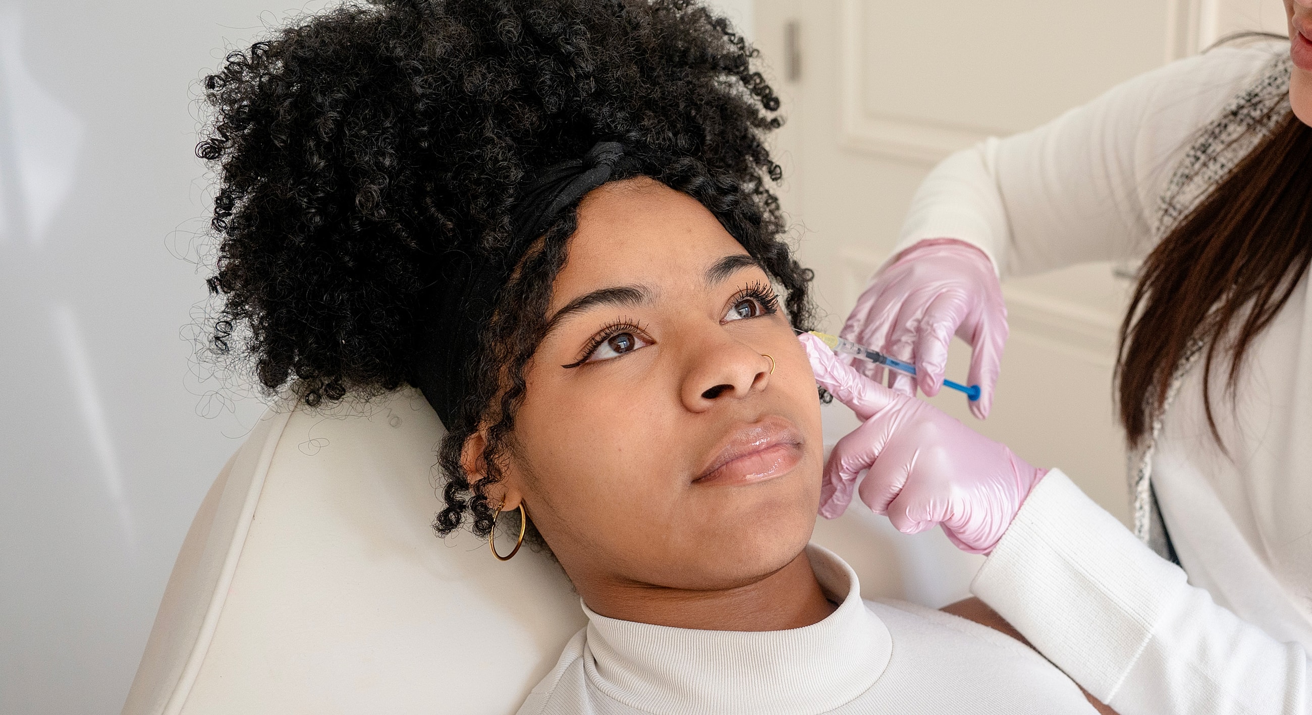 Client receiving facial treatment in beauty clinic.